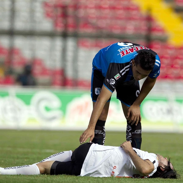 Gerardo Espinoza se queja de una fuerte entrada en el mediocampo.