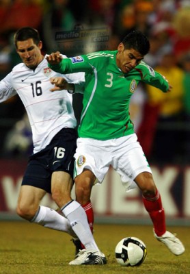 Sacha Kljestan choca con Carlos Salcido en pos del esférico.