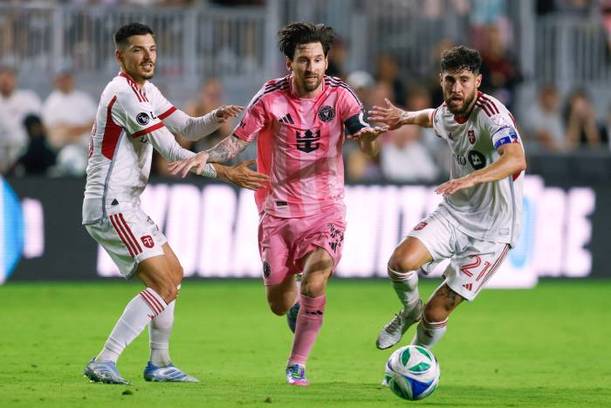 Messi intenta avanzar entre la marca del Toronto FC (AFP)