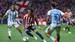 El centrocampista del Atlético de Madrid Arnau Ortiz intenta escaparse de Carlos Dotor (Málaga). FOTO: EFE